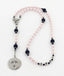 Personalized pink and dark blue girl’s baptism rosary with a name in beads.