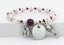 Pink pearl and purple crystal rosary bracelet with an engraved disc and charms.