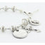 Crystal lined pearl rosary bracelet with an engraved disc and charms.