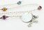 White pearl and multiple color birthstone family rosary with an engraved disc.
