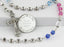 Multiple color birthstone personalized rosary with engraved disc and multiple names in beads.