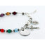 Multi color birthstone and pearl rosary bracelet with an engraved disc and charms.