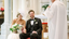 Bride & Groom sitting in front of priest at a catholic wedding.