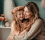 Mother and daughter smiling and hugging. 