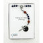 Boy’s dark blue baptism rosary with footballs in Charming Rosary gift box with card message.