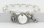 White pearl and crystal rosary bracelet with an engraved disc and charms for bridesmaids.