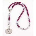 Purple crystal girl’s baptism rosary with lavender pearls and a name in beads.