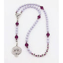 Girl’s lavender baptism with purple crystals and a name in beads.