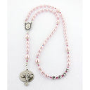 Pink fancy girl’s baptism rosary with a name in beads.