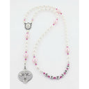 White and pink fancy girl’s baptism rosary with a name in beads.