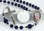 Dark blue memorial rosary beads with photo center and engraved disc.