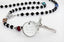 Black pearl and multicolored birthstone men's rosary with an engraved disc. 