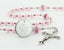 Custom pink quinceanera rosary, with an engraved disc for a girl's quinceanera gift.