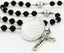 Custom black and grey first communion rosary, with an engraved disc for a boy’s communion gift.