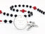 Custom dark black and red first communion rosary, with an engraved disc for a boy’s communion gift.