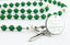 Custom green and white first communion rosary, with an engraved disc for a boy’s communion gift.