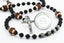 Custom black first communion rosary with footballs, an engraved disc, and a name in beads.