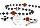 Custom black multi-sport first communion rosary with an engraved disc.