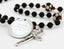 Black soccer first communion rosary with red beads and an engraved disc.