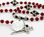 Custom red and black soccer first communion rosary with an engraved disc, and a name in beads.