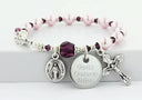 Pink pearl and purple crystal rosary bracelet with an engraved disc and charms. 