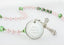 Pink first communion rosary with green crystals, an engraved disc and name in beads. For a girl’s communion gift.