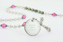 White, pink and green first communion rosary with an engraved disc, for a girl’s communion gift.