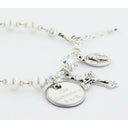 White pearl and crystal rosary bracelet with an engraved disc, cross and oval charms. 