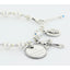 White pearl and crystal rosary bracelet with an engraved disc, cross and oval charms. 