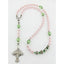 Girl’s pink first communion with green crystals and a name in beads. 