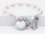 Pink pearl and crystal communion rosary bracelet with an engraved disc and charms. 