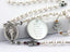 White pearl family rosary with angels and an engraved disc. 