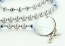 Custom grey pearl and blue crystal baptism rosary, with an engraved disc for a boy’s baptism gift.