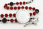 Custom red and black baptism rosary, with an engraved disc for a boy’s baptism gift.