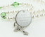 White baptism rosary with green crystals and an engraved disc, for a girl’s baptism gift.