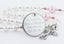 White and pink fancy baptism rosary with an engraved disc, for a girl’s baptism gift.