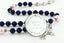 Custom dark blue and pink baptism rosary, with an engraved disc for a girl’s baptism gift.