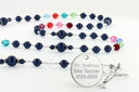 Custom rosary with blue pearls and multiple color birthstones with an engraved disc.