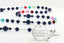 Custom rosary with blue pearls and multiple color birthstones with an engraved disc.