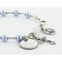 Light blue pearl and crystal rosary bracelet with an engraved disc and charms for a catholic wedding gift. 
