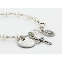 White pearl and crystal rosary bracelet with an engraved disc and charms for a catholic wedding gift. 